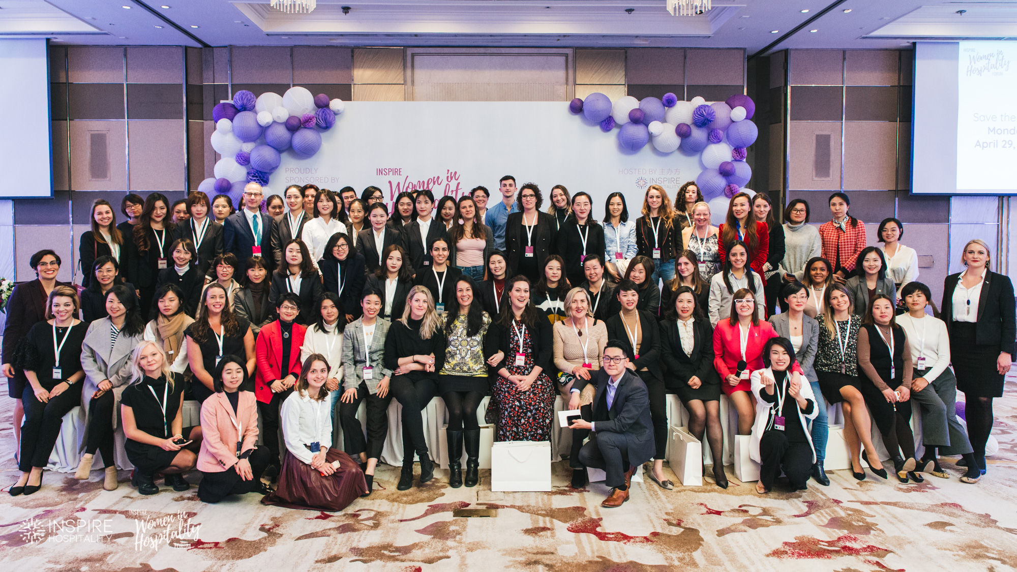 The full group of attendees in front of the Inspire Women in Hospitality Forum balloon backdrop